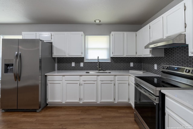 kitchen with white cabinets, sink, appliances with stainless steel finishes, and tasteful backsplash