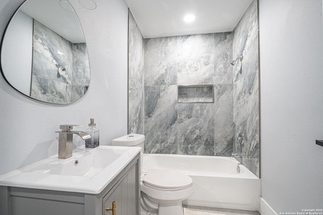 full bathroom with tiled shower / bath, vanity, and toilet