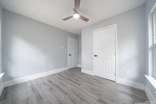 unfurnished bedroom with ceiling fan and light wood-type flooring