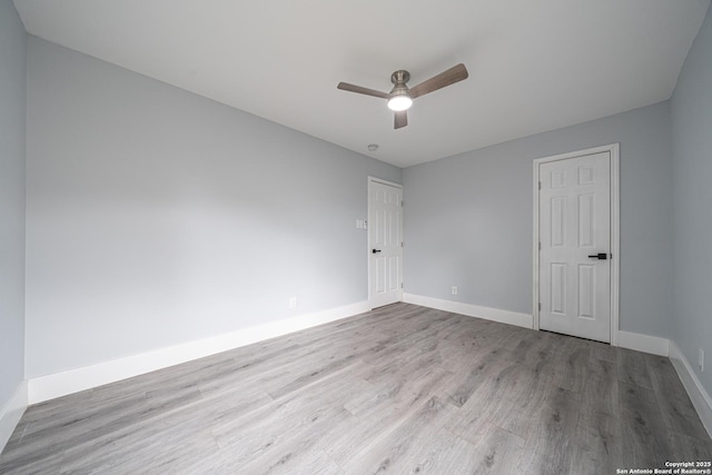 spare room with ceiling fan and light wood-type flooring