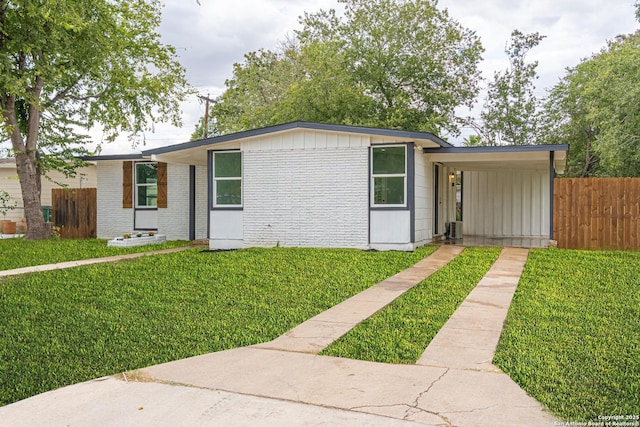 view of front of property with a front yard and a carport