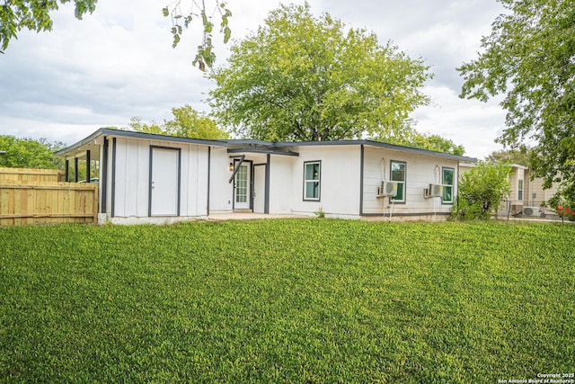 back of house with a yard and cooling unit