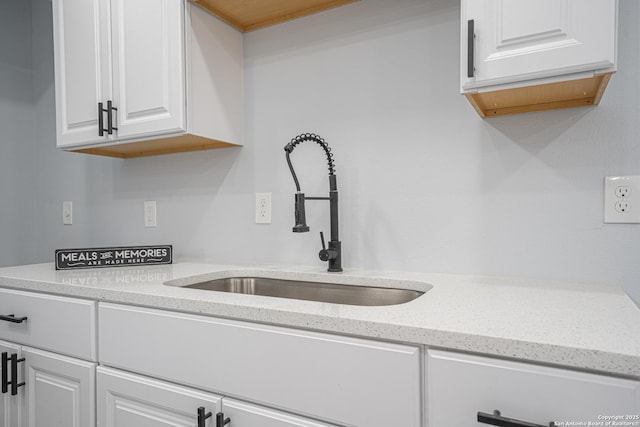 kitchen featuring white cabinets and sink