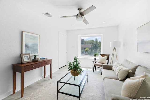 living room featuring ceiling fan and light hardwood / wood-style floors