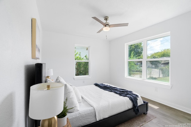 bedroom with hardwood / wood-style flooring and ceiling fan