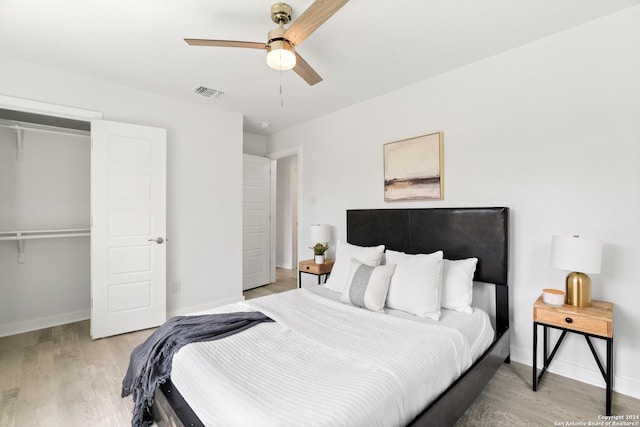 bedroom featuring ceiling fan, light wood-type flooring, and a closet