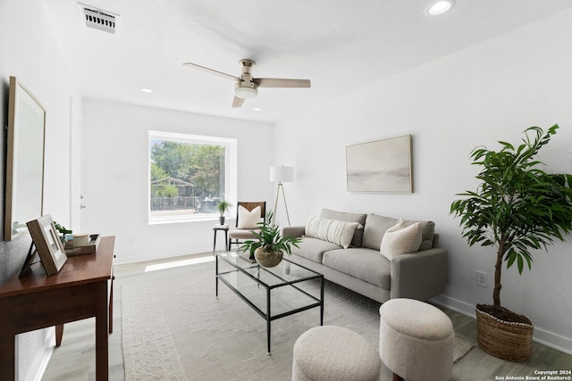 living room with ceiling fan and light hardwood / wood-style floors