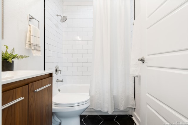 full bathroom featuring tile patterned flooring, vanity, toilet, and shower / bath combo with shower curtain