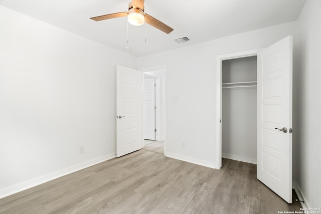 unfurnished bedroom featuring ceiling fan, a closet, and light hardwood / wood-style floors