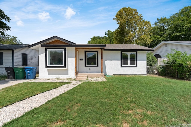 ranch-style home featuring a front yard