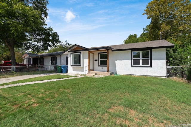 ranch-style home with a front yard