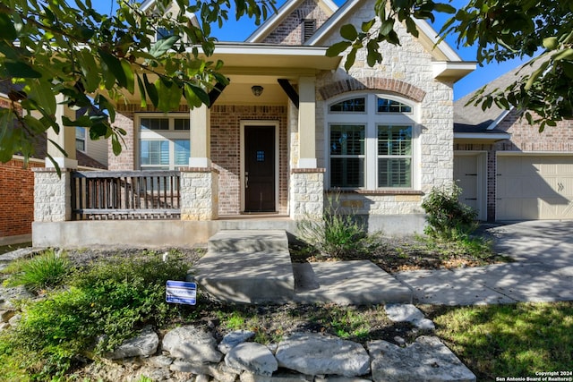 view of front of house featuring a porch and a garage