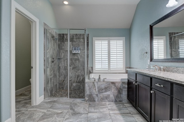 full bathroom featuring plenty of natural light, independent shower and bath, lofted ceiling, and vanity