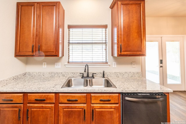 kitchen with a wealth of natural light, sink, stainless steel dishwasher, and french doors