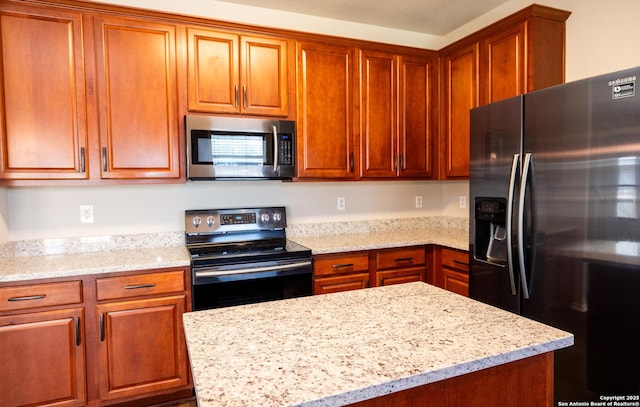 kitchen featuring light stone countertops and stainless steel appliances