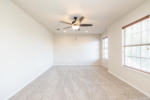 empty room featuring carpet flooring and ceiling fan