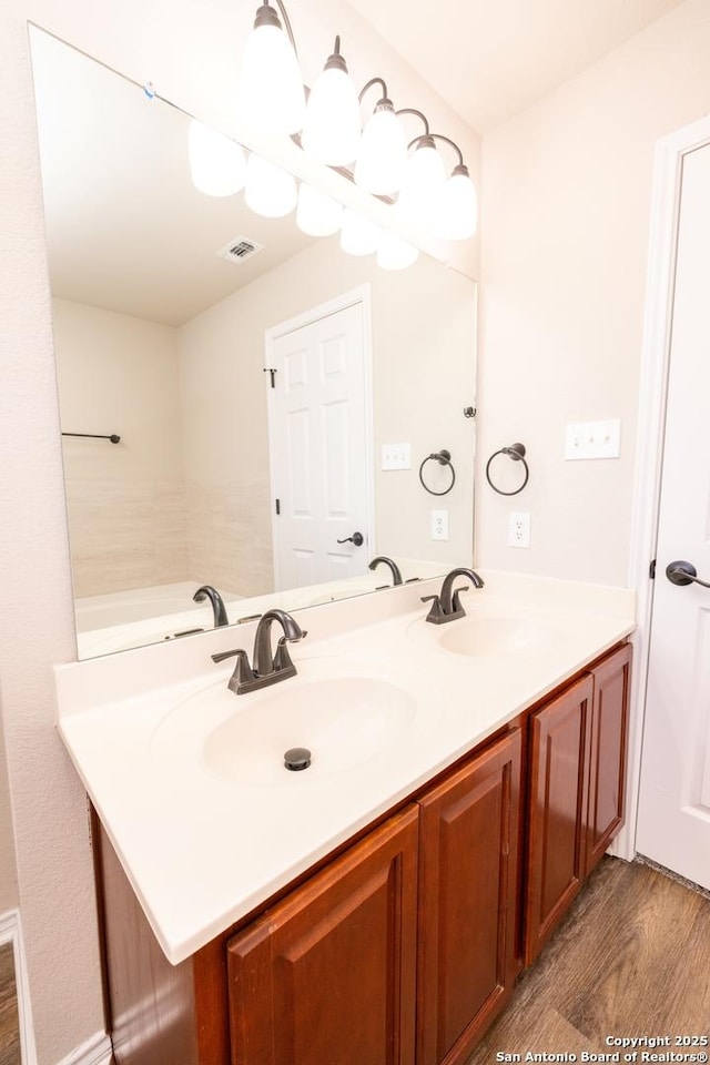 bathroom with hardwood / wood-style floors and vanity