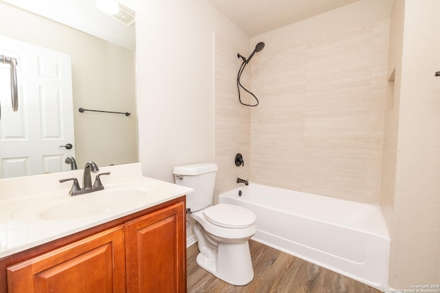 full bathroom with hardwood / wood-style floors, vanity, bathtub / shower combination, and toilet