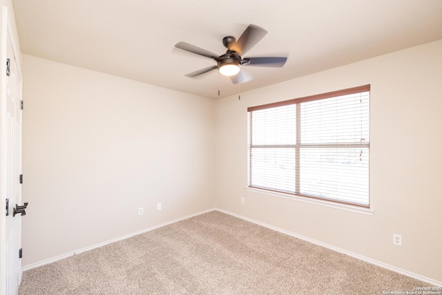 carpeted empty room featuring ceiling fan