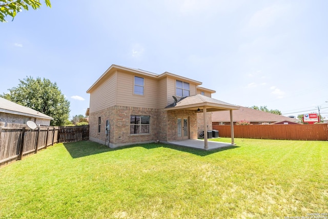 rear view of property featuring a patio area, a yard, and cooling unit