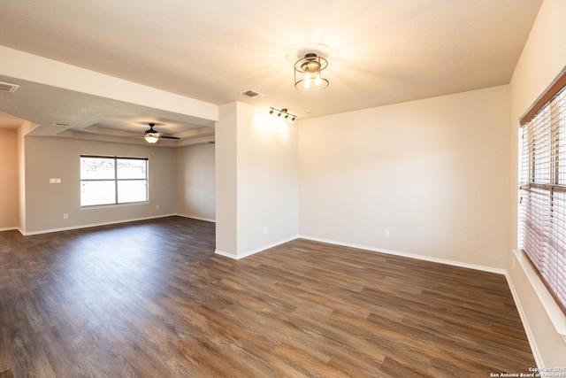 spare room with ceiling fan and dark wood-type flooring