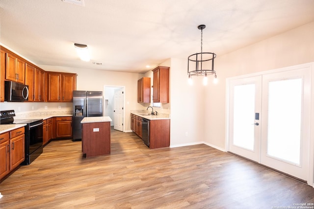 kitchen with dishwasher, a center island, stainless steel refrigerator with ice dispenser, hanging light fixtures, and electric range