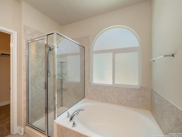 bathroom with shower with separate bathtub