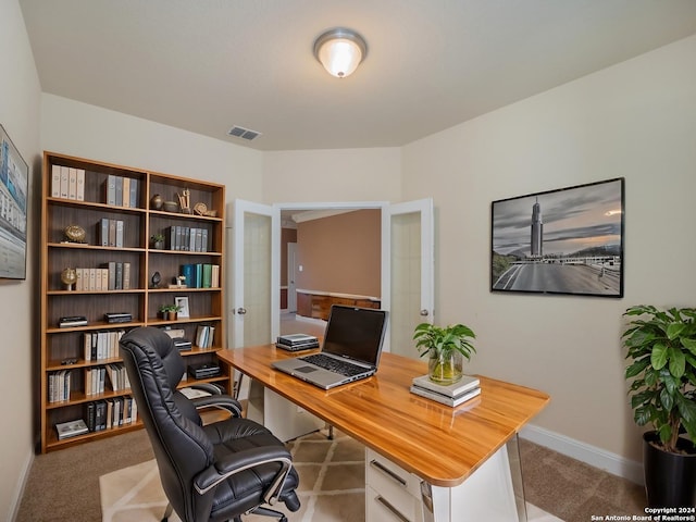 home office featuring french doors and light colored carpet