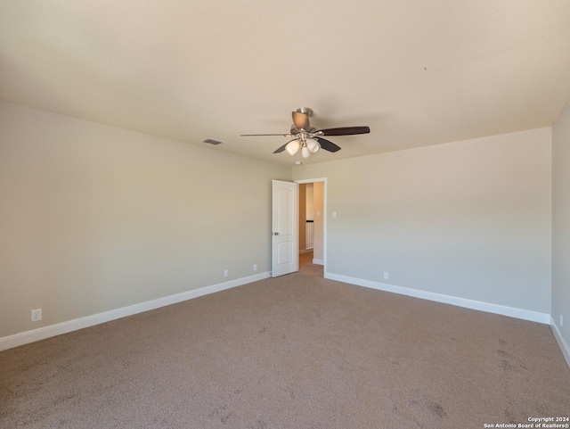 unfurnished room with ceiling fan and light carpet