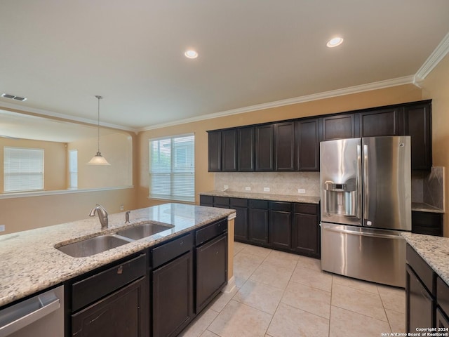 kitchen featuring light stone countertops, ornamental molding, stainless steel appliances, sink, and hanging light fixtures