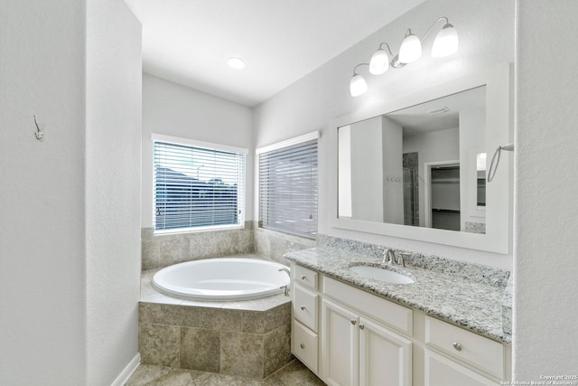 bathroom featuring vanity and separate shower and tub