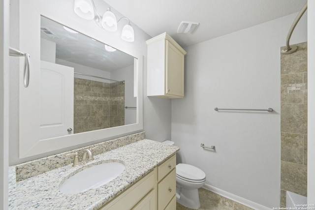 full bathroom featuring tile patterned floors, vanity, tiled shower / bath combo, and toilet