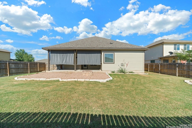 rear view of house featuring a lawn and a patio area