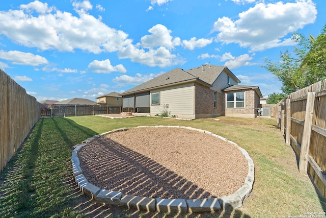 rear view of property with a yard