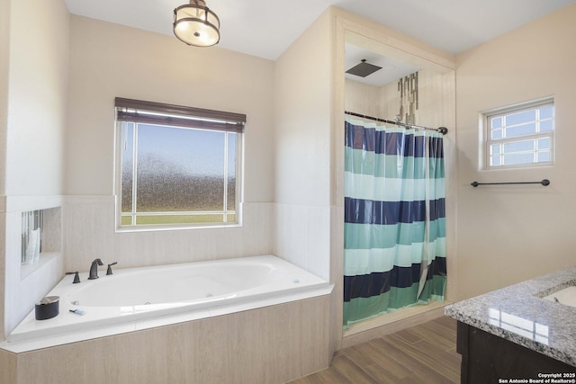 bathroom with vanity and independent shower and bath