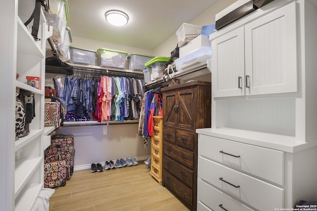 walk in closet featuring light hardwood / wood-style flooring