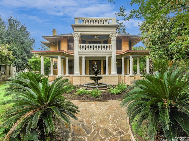 rear view of property with a balcony