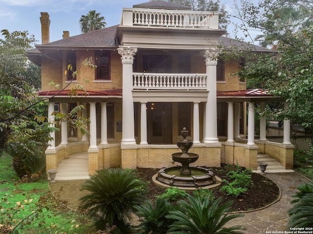 rear view of house with a balcony