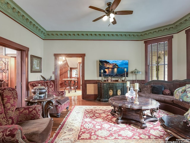 living room featuring ceiling fan, hardwood / wood-style flooring, and ornamental molding