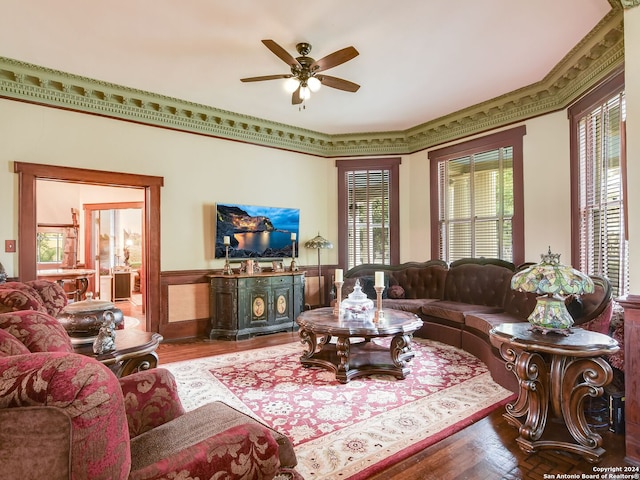 living room featuring hardwood / wood-style flooring, ceiling fan, plenty of natural light, and ornamental molding