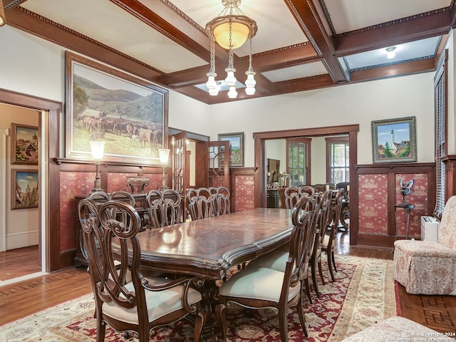 dining area with hardwood / wood-style floors, beamed ceiling, and coffered ceiling