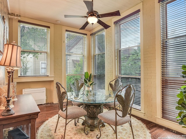 dining room with ceiling fan and dark wood-type flooring