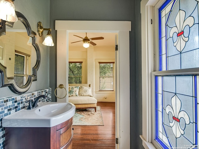 bathroom featuring tasteful backsplash, ceiling fan, hardwood / wood-style floors, and vanity