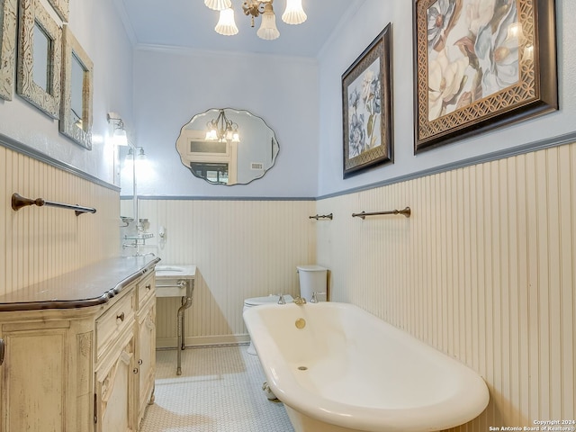 bathroom with a bath, vanity, tile patterned floors, and crown molding