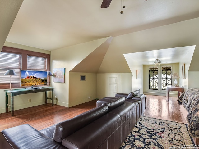 living room featuring wood-type flooring, ceiling fan, and lofted ceiling