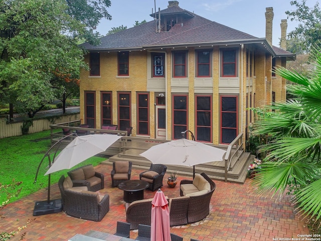 rear view of house featuring outdoor lounge area and a patio