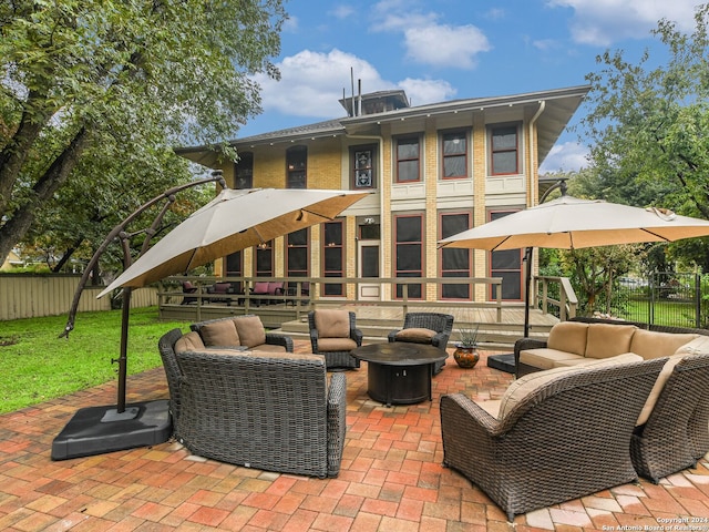 view of patio featuring an outdoor living space with a fire pit