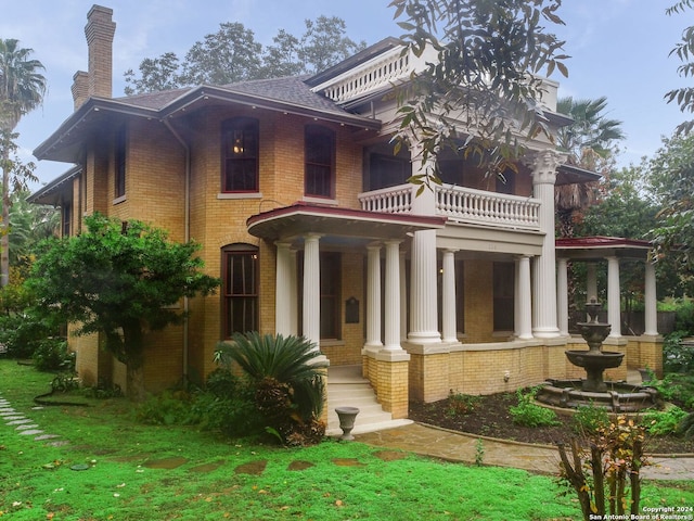 view of front of house featuring a balcony