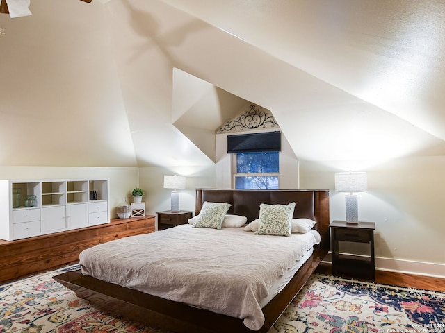 bedroom featuring hardwood / wood-style floors and vaulted ceiling