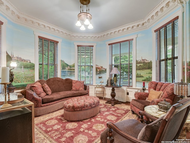 living room featuring a chandelier and crown molding